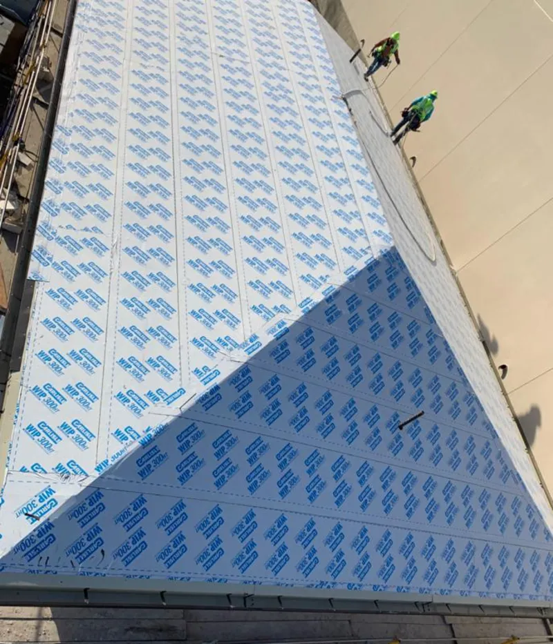 Professional roofers installing underlayment on a metal roof in Richton Park